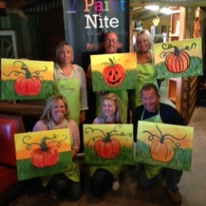 Artists show off their completed paintings at the JAES Paint Nite at Red Roost.