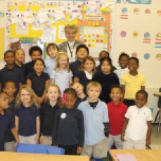 Volunteer Janet Phillips snaps a photo with her class